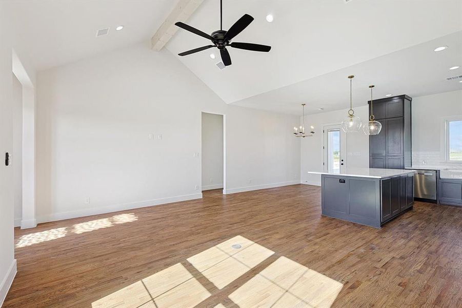 Kitchen with beam ceiling, a kitchen island, dark hardwood / wood-style flooring, dishwasher, and pendant lighting