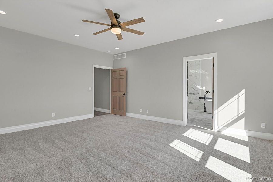 Primary suite showing access to bathroom