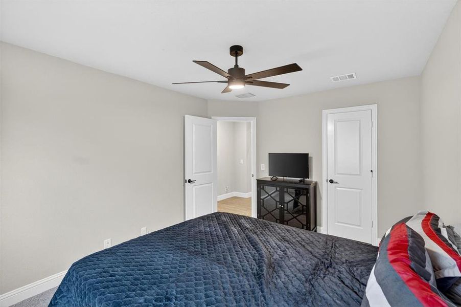 Room featuring light neutral wall paint, white trim, and a contemporary ceiling fan Room featuring light neutral wall paint, white trim, and a contemporary ceiling fan