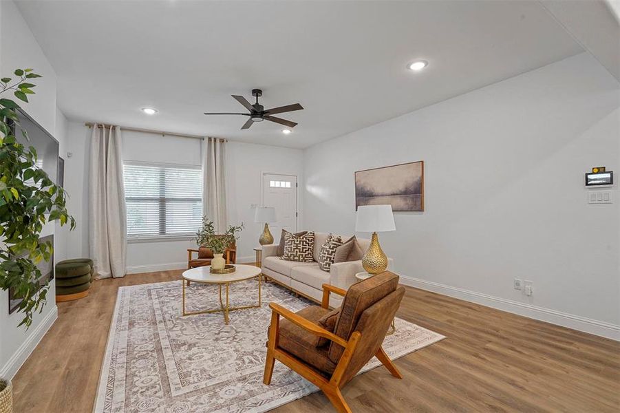 Living room featuring ceiling fan and wood-type flooring