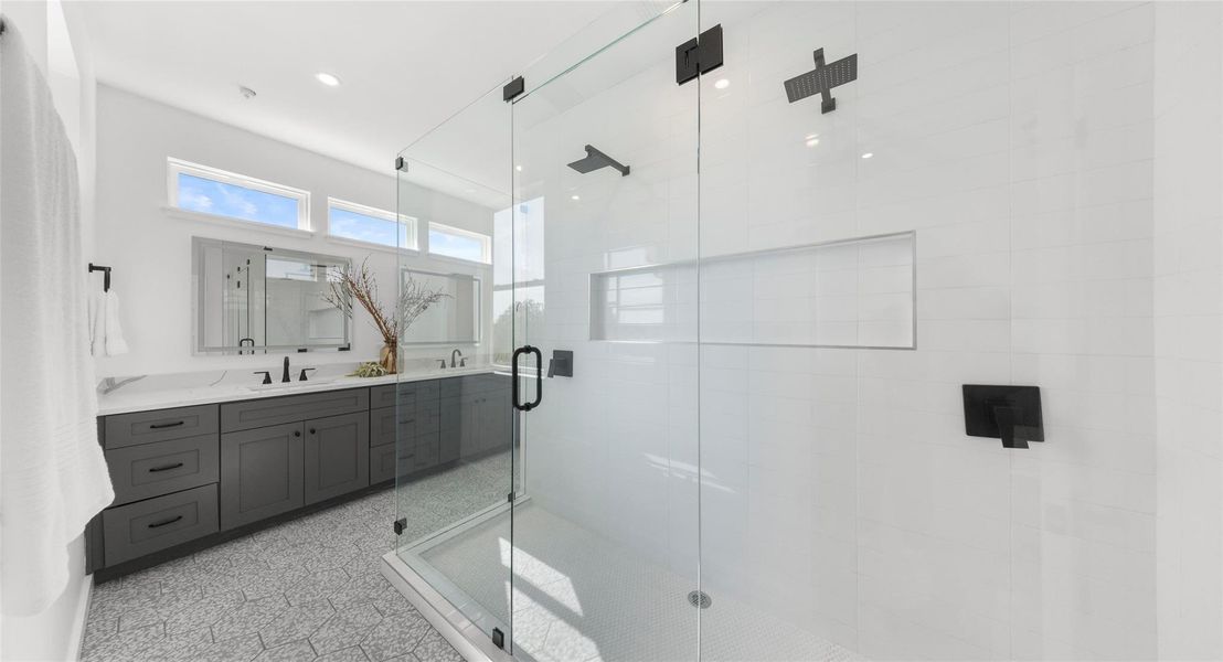 A light-filled primary bath beneath a vaulted ceiling, with a walk-in shower made for unwinding. Model No. 105 Shown.