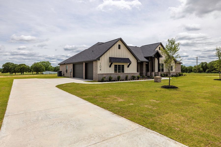 Front exterior of a new home in Prairie Winds Estates, Poolville, TX, highlighting curb appeal (Image 24). Front exterior of a new home in Prairie Winds Estates, Poolville, TX, highlighting curb appeal (Image 24).