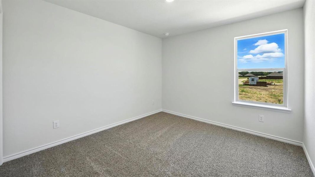 Spare room with carpet flooring and baseboards