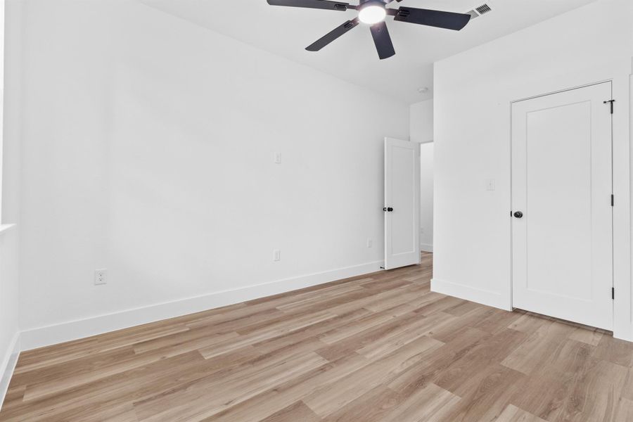Unfurnished bedroom with light wood-type flooring and a ceiling fan