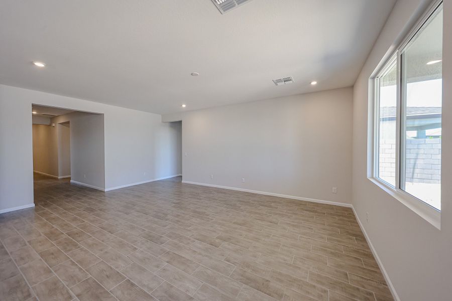 A room with a wood floor and windows. A room with a wood floor and windows.