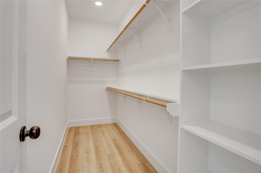 The primary bedroom has an enormous walk in closet with built ins.