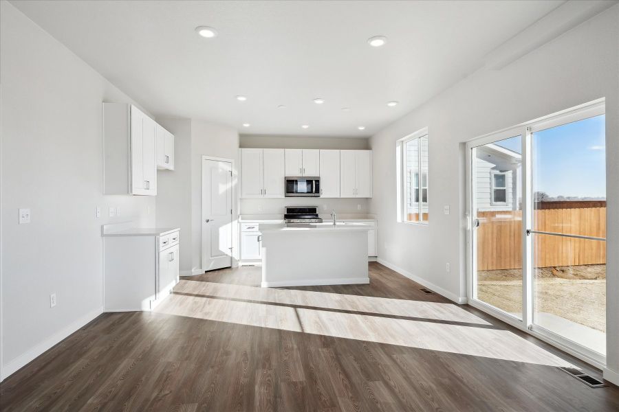 A large kitchen with white cabinets.