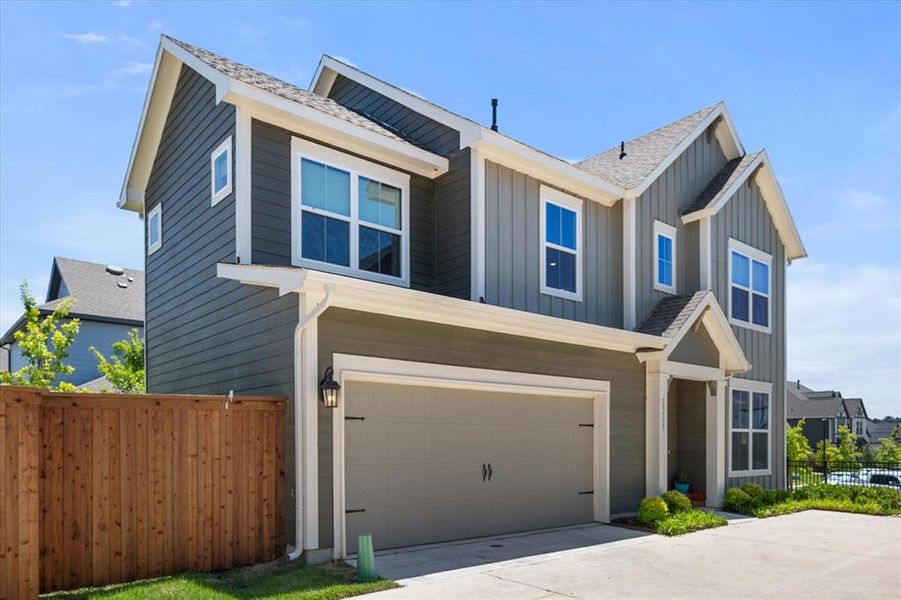 Front exterior of a new home in Walsh Gardens, Fort Worth, TX, highlighting curb appeal (Image 2). Front exterior of a new home in Walsh Gardens, Fort Worth, TX, highlighting curb appeal (Image 2).