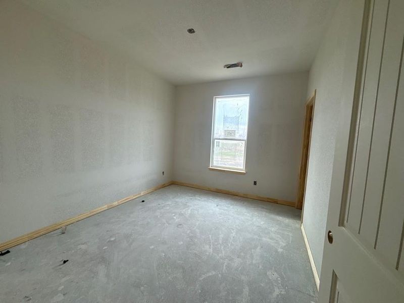 Unfurnished room with baseboards and concrete floors Unfurnished room with baseboards and concrete floors