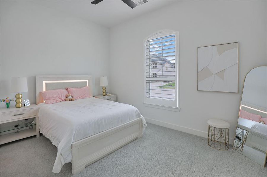 Bedroom featuring light gray carpeting and white painted walls
