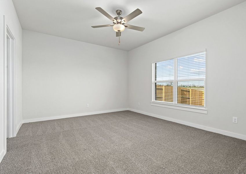 The spacious master bedroom has a window that lets in great, natural light and backyard views.