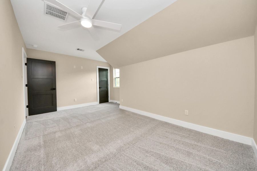 Bedroom 4. Spacious secondary bedrooms featuring soft carpet, large windows that provide abundant natural light, and ample closet space.