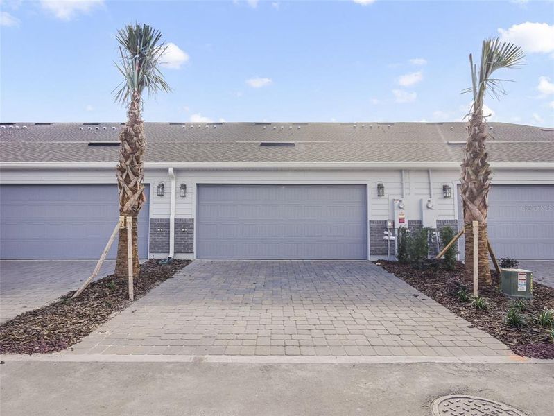 Front exterior of a new home in Aulin Square, Oviedo, FL, highlighting curb appeal (Image 22).