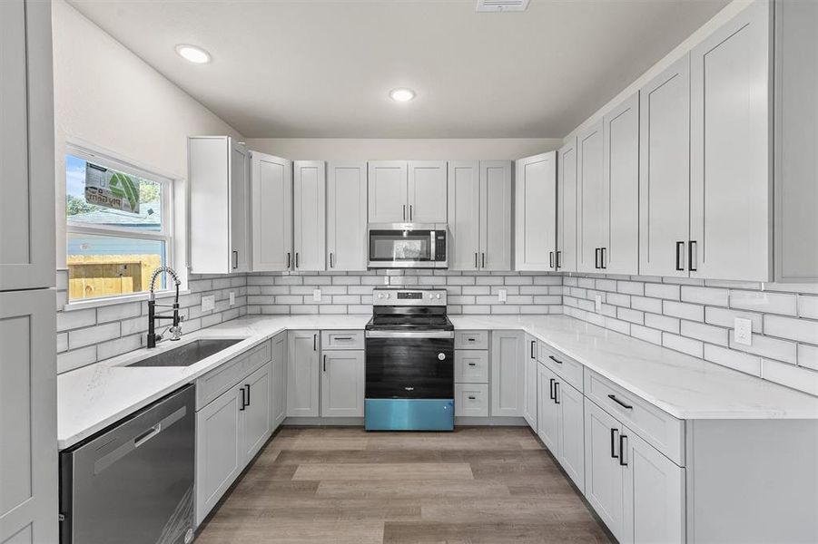 Quartz countertops and chic backsplash