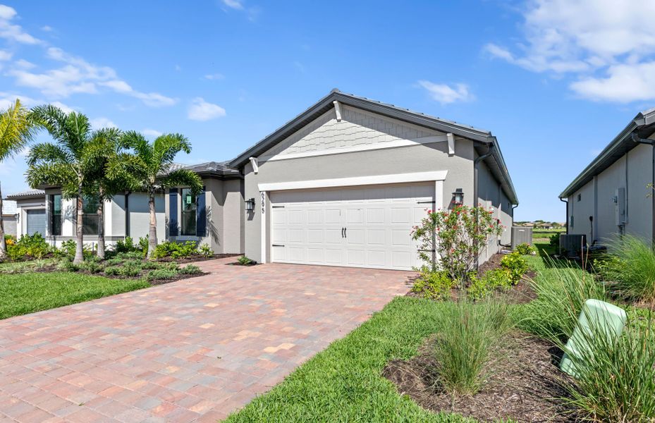Front exterior of a new home in Del Webb Naples, Immokalee, FL, highlighting curb appeal (Image 24).