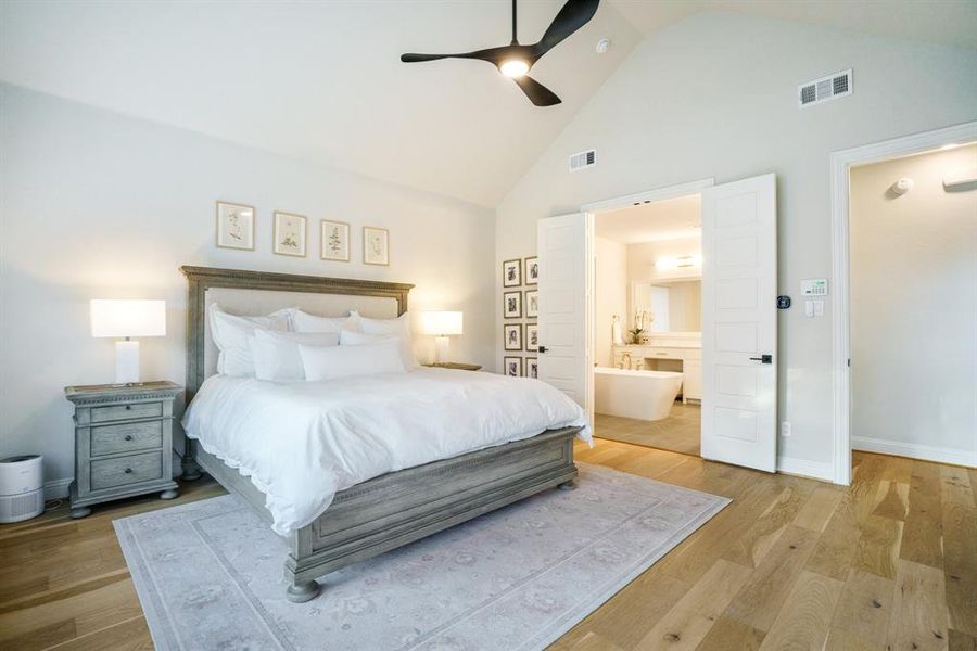 Restful and Refined - The owner's suite offers an inviting retreat with vaulted ceilings, white oak flooring, and direct views into the spa-like ensuite bath. Restful and Refined - The owner's suite offers an inviting retreat with vaulted ceilings, white oak flooring, and direct views into the spa-like ensuite bath.