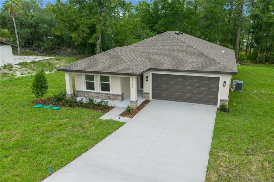 Front exterior of a new home in , Weeki Wachee, FL, highlighting curb appeal (Image 27).
