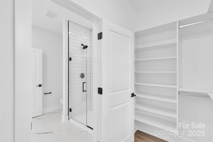 Primary bedroom walk-in closet Primary bedroom walk-in closet