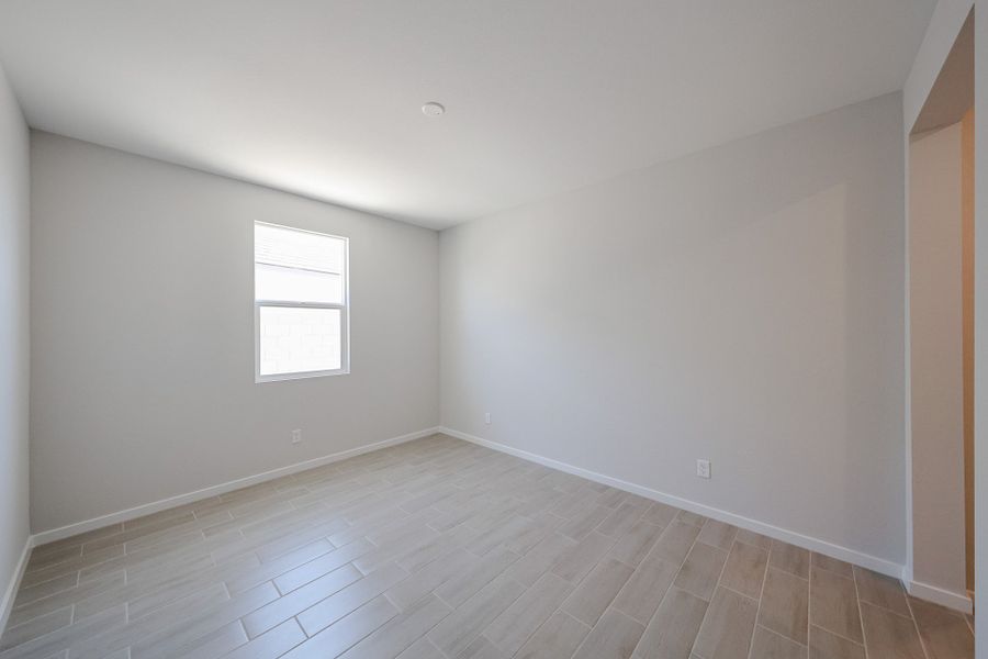 A room with a tile floor and windows.