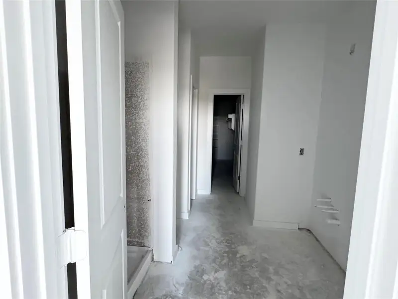 Corridor featuring unfinished concrete flooring Corridor featuring unfinished concrete flooring