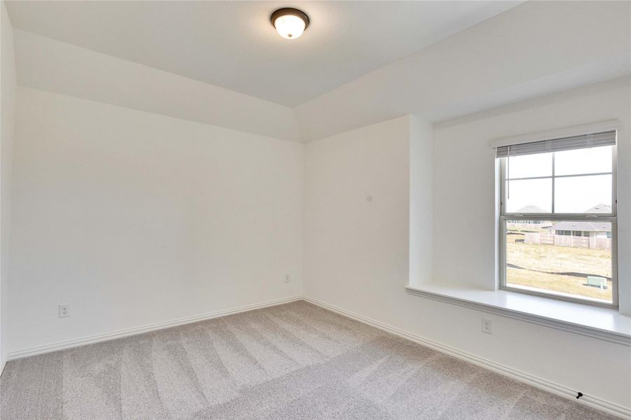 Carpeted empty room featuring baseboards