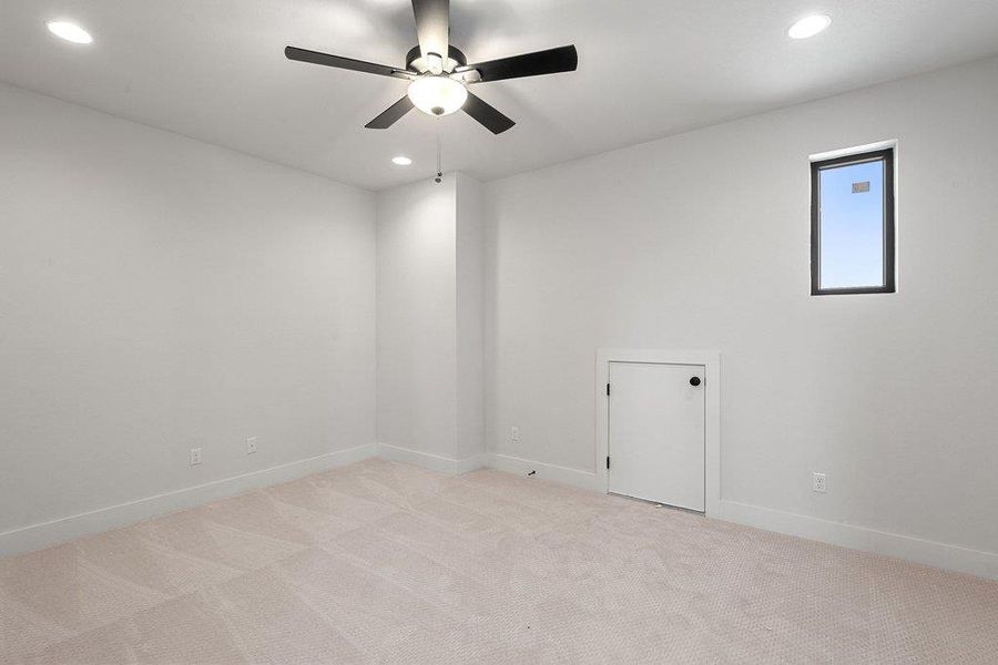 Empty room featuring light colored carpet, recessed lighting, and a ceiling fan