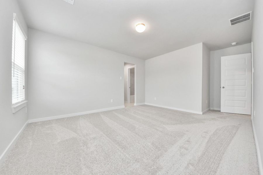 Secondary bedroom features plush carpeting, large windows that let in plenty of natural light, bright paint, and spacious closets. Sample photo of completed home with similar floor plan. Actual colors and selections may vary. Secondary bedroom features plush carpeting, large windows that let in plenty of natural light, bright paint, and spacious closets. Sample photo of completed home with similar floor plan. Actual colors and selections may vary.
