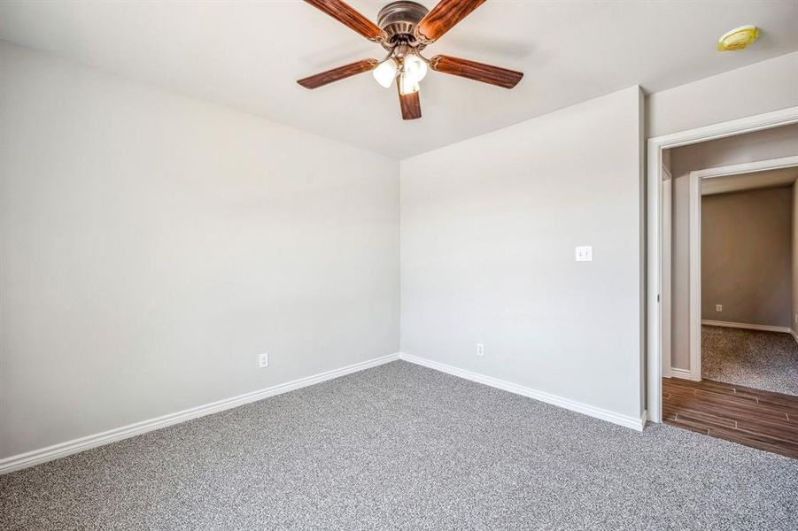 Unfurnished room featuring ceiling fan and hardwood / wood-style floors