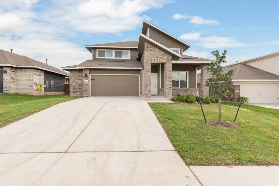 Front exterior of a new home in Plum Creek North, Kyle, TX, highlighting curb appeal (Image 2). Front exterior of a new home in Plum Creek North, Kyle, TX, highlighting curb appeal (Image 2).