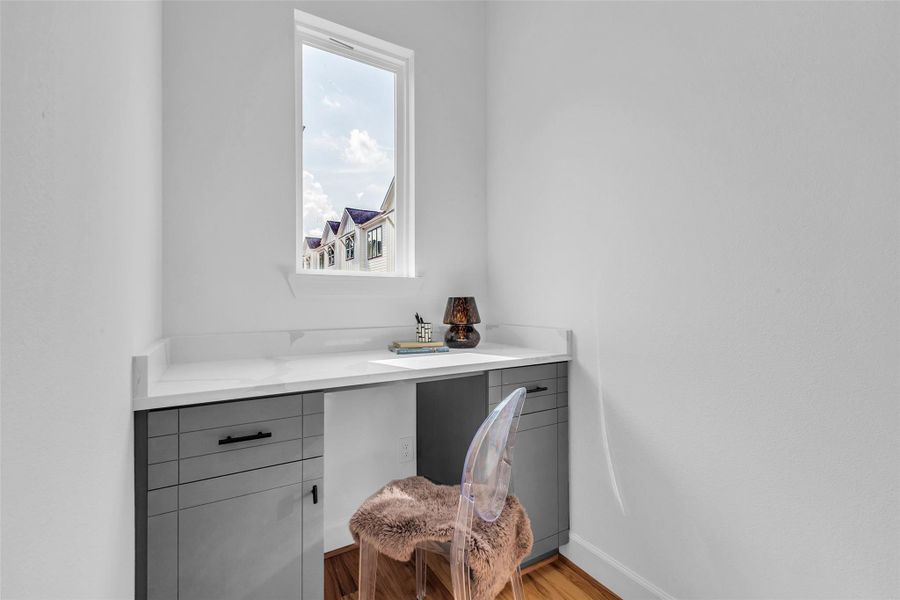 A cozy, bright workspace with a built-in desk in the living room. A cozy, bright workspace with a built-in desk in the living room.