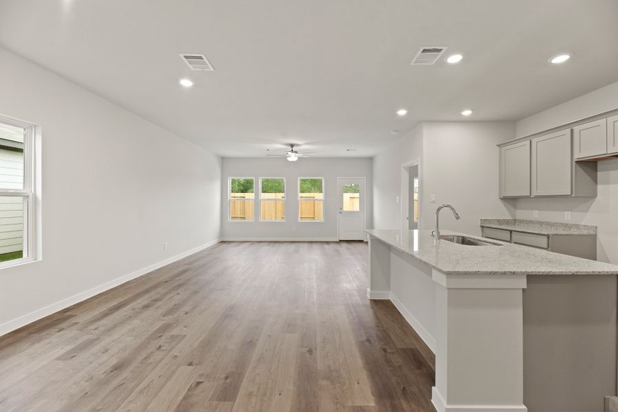 A kitchen with a wood floor.