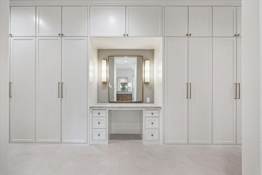 Enormous primary closet with dressing vanity! Tons of storage behind custom doors! A buyer's Dream! Enormous primary closet with dressing vanity! Tons of storage behind custom doors! A buyer's Dream!