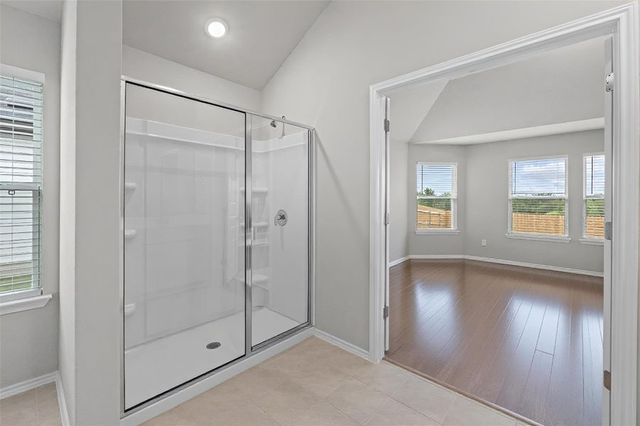 A spacious step-in shower sits right across from the vanity, keeping everything you need in one convenient spot A spacious step-in shower sits right across from the vanity, keeping everything you need in one convenient spot