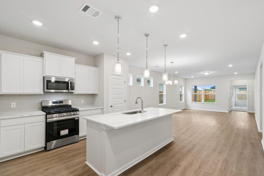 The Oakshire II- Kitchen in Dining Area and Family Room. Sample image for illustration; upgrades, options, and colors may vary. The Oakshire II- Kitchen in Dining Area and Family Room. Sample image for illustration; upgrades, options, and colors may vary.
