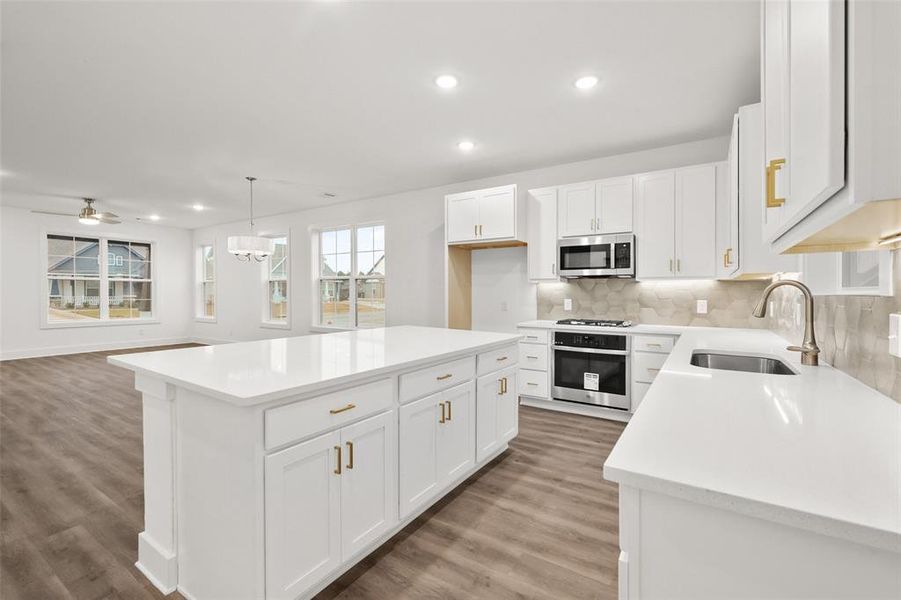 Kitchen with white cabinetry and stainless steel appliances