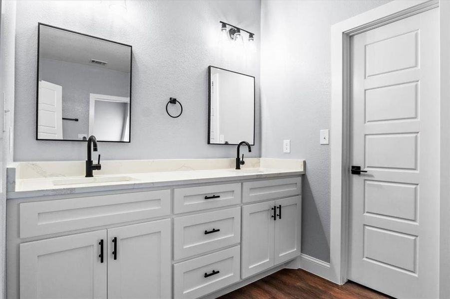 Bathroom featuring hardwood / wood-style flooring and vanity