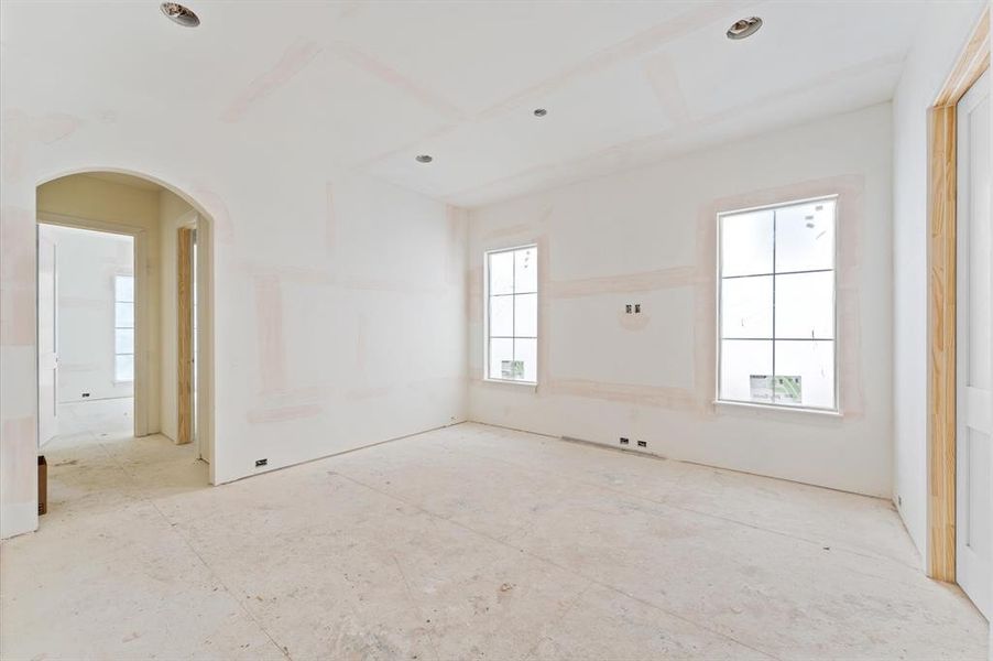 The second floor includes a large game room and bath with dual access. Striking arched doorway leads to another bedroom/bathroom.