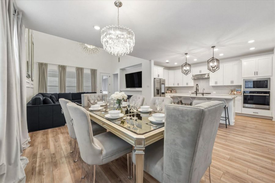 Open-concept living space featuring, recessed lighting, and a crystal chandelier