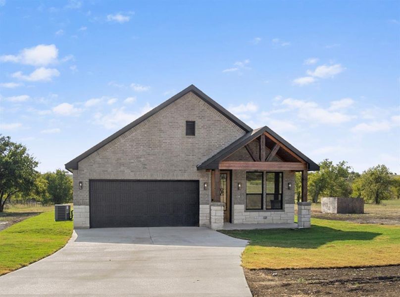 View of front of house with a front lawn and a garage