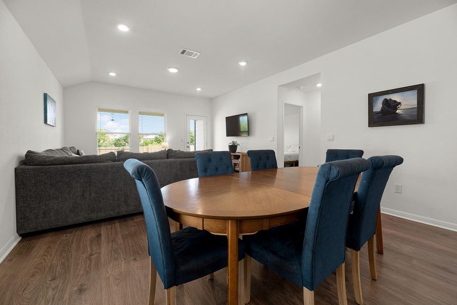 Dining space featuring dark wood-style floors, recessed lighting, and lofted ceiling
