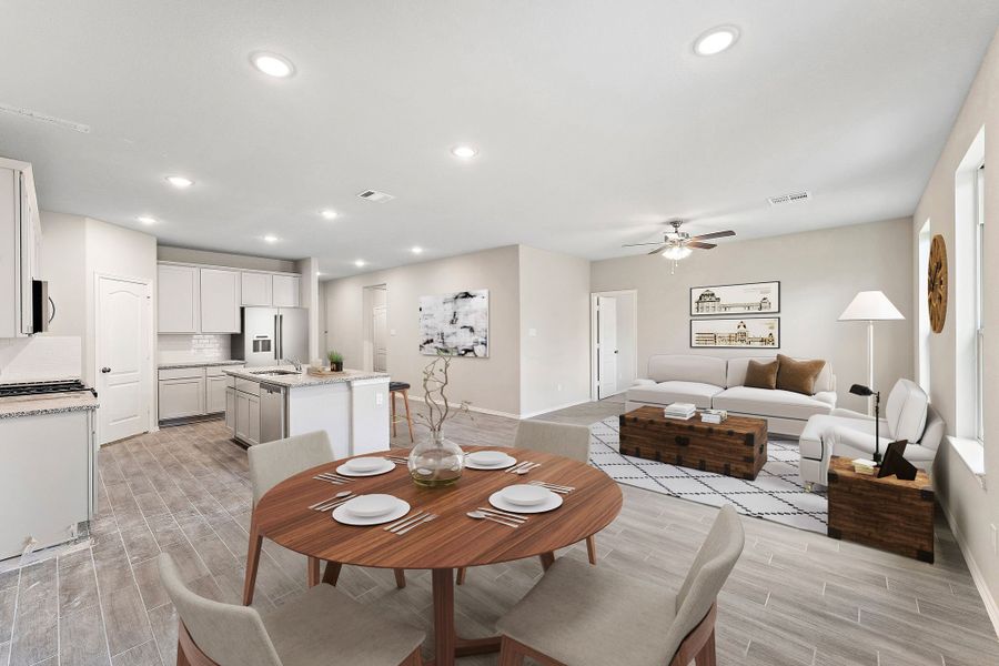 A large living room with a dining table and couches. A large living room with a dining table and couches.