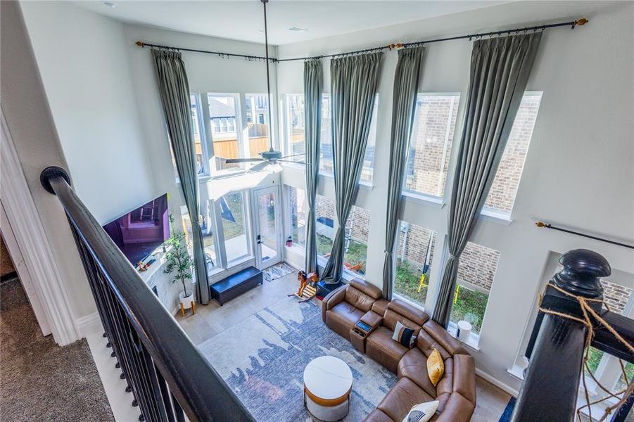 Living room featuring plenty of natural light and a high ceiling