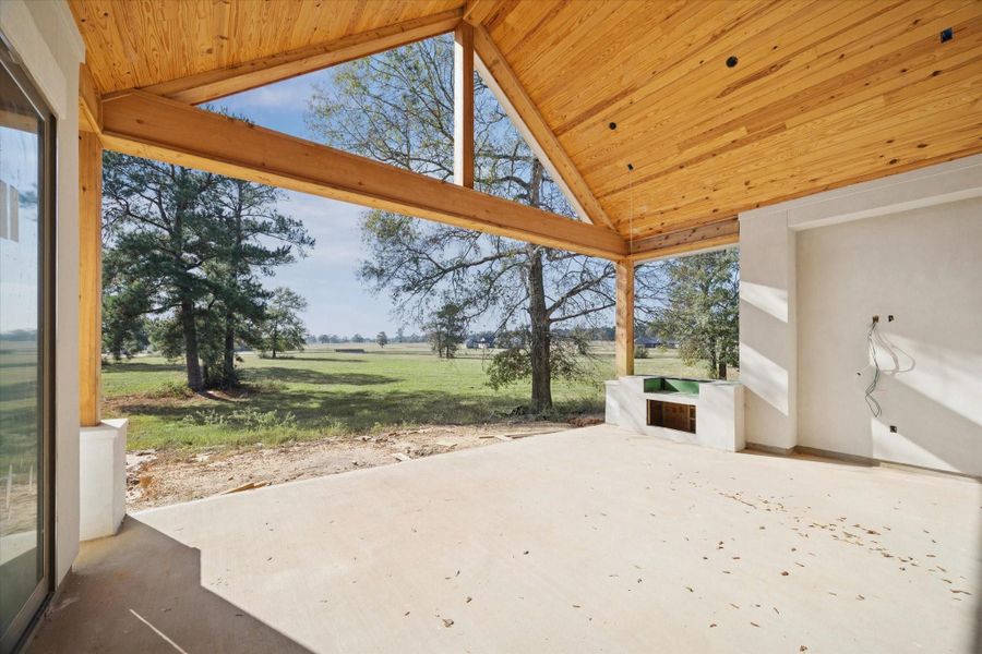 The rear pavilion features a vaulted cedar ceiling and generous covered space ideal for outdoor dining, grilling, or lounging. Its open layout frames peaceful views of the backyard and surrounding landscape. A beautifully crafted outdoor extension of the home by Jeff Paul Custom Homes.