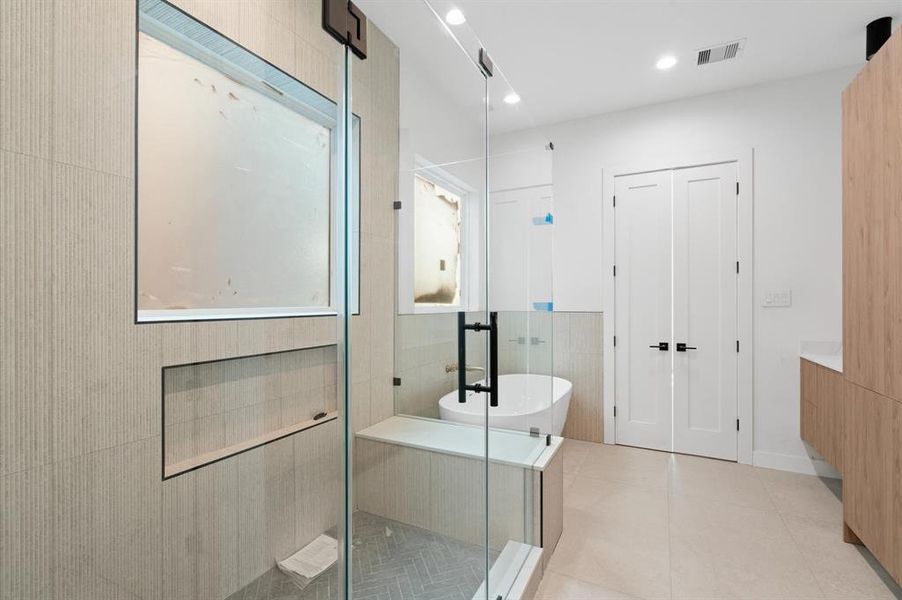 Spa like ensuite primary bathroom has a massive walk-in shower.