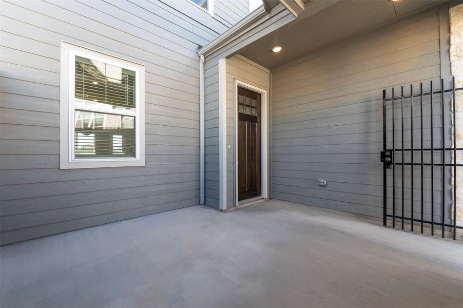 Covered front porch with private entry, modern exterior finishes, and welcoming curb appeal.