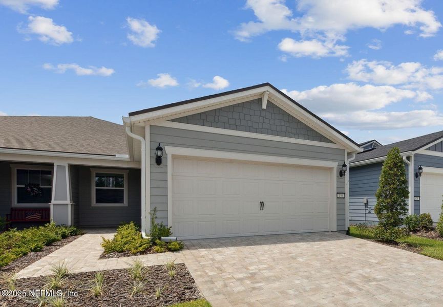 Front exterior of a new home in Del Webb Wildlight, Wildlight, FL, highlighting curb appeal (Image 1). Front exterior of a new home in Del Webb Wildlight, Wildlight, FL, highlighting curb appeal (Image 1).