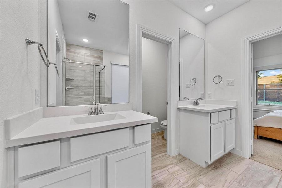 Full bathroom featuring a shower stall, two vanities, ensuite bath, and recessed lighting Full bathroom featuring a shower stall, two vanities, ensuite bath, and recessed lighting