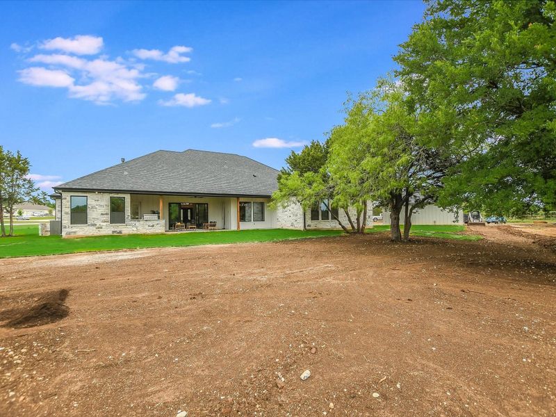 Rear backyard view of home, ready for a pool, outdoor entertaining area, play area, garden and more. Extra spacious backyard!