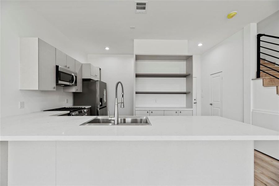 Quartz counters add to a beautiful designer feel.