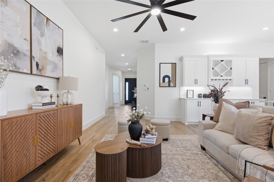 Natural light illuminates this spacious great room with built-in cabinetry and a striking ceiling fan. Natural light illuminates this spacious great room with built-in cabinetry and a striking ceiling fan.